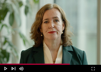 Portrait of Sarah Rapson in an office setting, looking directly at the camera.