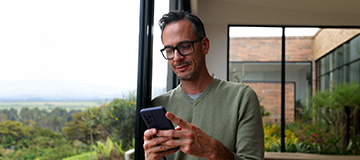 A man looks at his phone searching for information